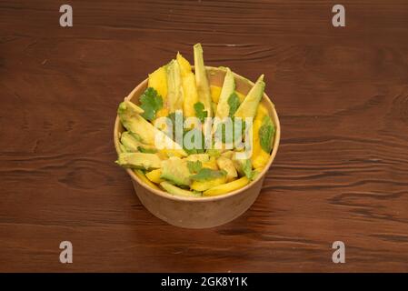 Mango, avocado and coriander salad inside a cardboard bowl for home delivery Stock Photo