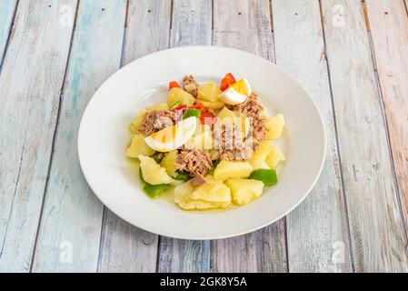 country salad with delicious potatoes and hard-boiled eggs, tuna, and green and red pepper Stock Photo