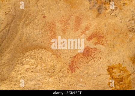 closeup of an ancient aboriginal hand print art on a rock shelter wall at dunns swamp Stock Photo