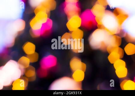 Blurred lights abstract background in the night, defocused dark glowing bokeh backdrop, magical illuminated sparkle pattern. Stock Photo