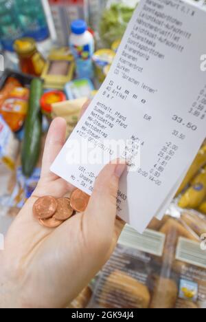receipt in a hand with last cents, Germany Stock Photo