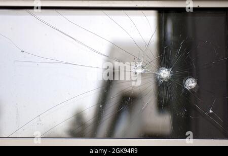bullet holes in a glass panel Stock Photo