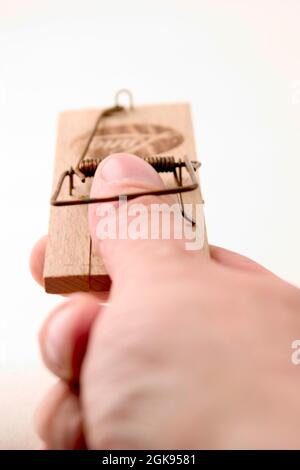 thumb in a mousetrap Stock Photo