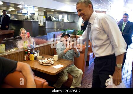 President Barack Obama greets patrons at Canter's Delicatessen in Los Angeles, Calif., July 24, 2014. (Official White House Photo by Pete Souza) This official White House photograph is being made available only for publication by news organizations and/or for personal use printing by the subject(s) of the photograph. The photograph may not be manipulated in any way and may not be used in commercial or political materials, advertisements, emails, products, promotions that in any way suggests approval or endorsement of the President, the First Family, or the White House. Stock Photo