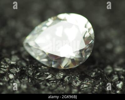 Close up shoot of pear shape diamond. Capture on black background. Stock Photo