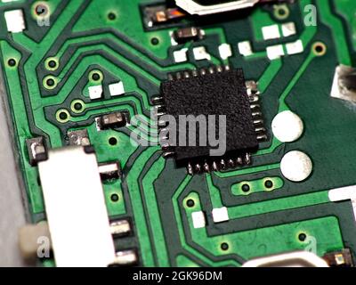 Green Printed Circuit Board (PCB) with some Surface Mount Device (SMD) components and chips. Shoot on white isolated background. Stock Photo