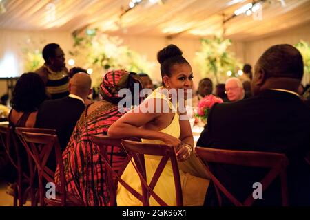 First Lady Michelle Obama talks with President Ali Bongo Ondimba of the Gabonese Republic during the U.S.-Africa Leaders Summit dinner on the South Lawn of the White House, Aug. 5, 2014. (Official White House Photo by Pete Souza) This official White House photograph is being made available only for publication by news organizations and/or for personal use printing by the subject(s) of the photograph. The photograph may not be manipulated in any way and may not be used in commercial or political materials, advertisements, emails, products, promotions that in any way suggests approval or endorse Stock Photo