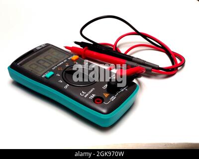 Picture of a digital multimeter, with red and black probe. Shoot on a white isolated background Stock Photo