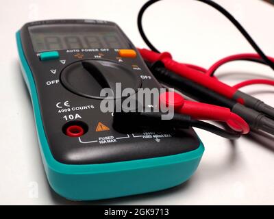 Picture of a digital multimeter, with red and black probe. Shoot on a white isolated background Stock Photo