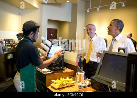 President Barack Obama and Chief of Staff Denis McDonough place an order at Starbucks on Pennsylvania Avenue in Washington, D.C., June 9, 2014. (Official White House Photo by Pete Souza) This official White House photograph is being made available only for publication by news organizations and/or for personal use printing by the subject(s) of the photograph. The photograph may not be manipulated in any way and may not be used in commercial or political materials, advertisements, emails, products, promotions that in any way suggests approval or endorsement of the President, the First Family, or Stock Photo