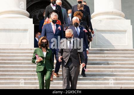 Washington DC, USA. 13th Sep 2021. House Speaker Nancy Pelosi (D-CA) (bottom left), House Minority Leader Kevin McCarthy (R-CA) (top left), Senate Majority Leader Chuck Schumer (D-NY) (bottom right), and House Majority Leader Steny Hoyer (D-MD) (top right) lead members of Congress down the center steps for a ceremony on the Capitol steps in remembrance of the victims of the September 11th attacks. Credit: Allison Bailey/Alamy Live News Stock Photo