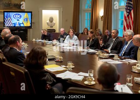 President Barack Obama meets with Cabinet members on the domestic response to Ebola, in the Cabinet Room of the White House, Oct.15, 2014. Dr. Tom Frieden, Director of the Centers for Disease Control and Prevention, participates via video teleconference. (Official White House Photo by Pete Souza) This official White House photograph is being made available only for publication by news organizations and/or for personal use printing by the subject(s) of the photograph. The photograph may not be manipulated in any way and may not be used in commercial or political materials, advertisements, email Stock Photo