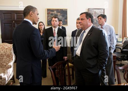 President Barack Obama greets New Jersey Governor Chris Christie and members of his staff in Chief of Staff Jack Lew's office in the West Wing of the White House, Dec. 6, 2012. (Official White House Photo by Pete Souza) This official White House photograph is being made available only for publication by news organizations and/or for personal use printing by the subject(s) of the photograph. The photograph may not be manipulated in any way and may not be used in commercial or political materials, advertisements, emails, products, promotions that in any way suggests approval or endorsement of th Stock Photo