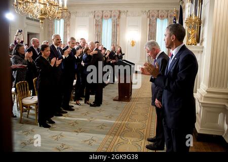 Defense Secretary Chuck Hagel bows his head to the applause of President Barack Obama and attendees following the announcement of Hagel's resignation in the State Dining Room of the White House, Nov. 24, 2014. (Official White House Photo by Pete Souza) This official White House photograph is being made available only for publication by news organizations and/or for personal use printing by the subject(s) of the photograph. The photograph may not be manipulated in any way and may not be used in commercial or political materials, advertisements, emails, products, promotions that in any way sugge Stock Photo