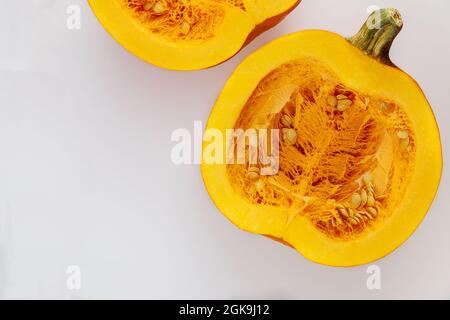 Seasonal cut pumpkin isolated on white background. Stock Photo