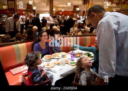 Oct. 25, 2013'A young girl captures the President's attention as he greeted customers at Junior's Cheesecake with New York City mayoral candidate Bill de Blasio in Brooklyn.'  (Official White House Photo by Pete Souza)  This official White House photograph is being made available only for publication by news organizations and/or for personal use printing by the subject(s) of the photograph. The photograph may not be manipulated in any way and may not be used in commercial or political materials, advertisements, emails, products, promotions that in any way suggests approval or endorsement of th Stock Photo