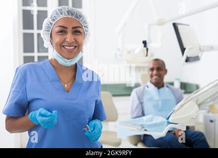 Smiling professional dentist woman posing in dental clinic Stock Photo