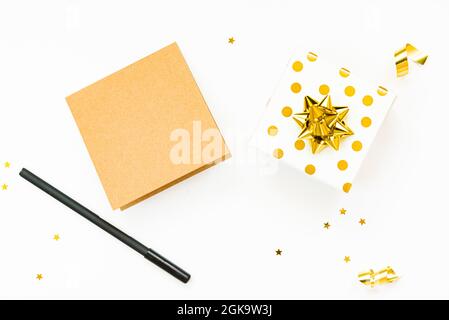 Top view of golden dotted gift boxes and empty card on a white background. Copy space, mock-up. Stock Photo