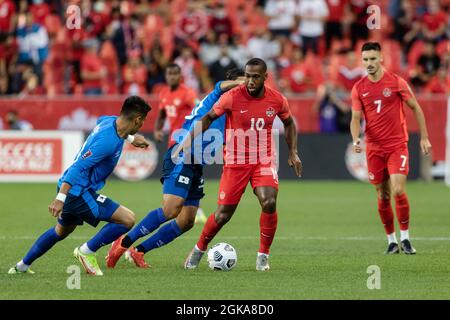 Toronto, Canada, September 8, 2021: Junior Hoilett, No.10, of Team Canada in action against two players of Team El Salvador (blue) during the CONCACAF World Cup Qualifying 2022 match at BMO Field in Toronto, Canada. Canada won the match 3-0. Stock Photo