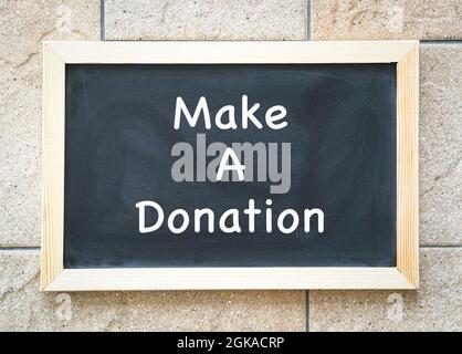 Blackboard with message, Make a Donation. Charity concept.