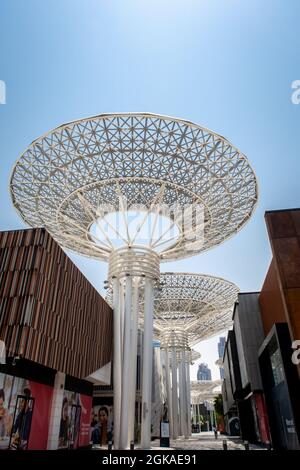 Dubai, UAE, 04/07/20. Modern artificial tree constructions and shopping street on Dubai Bluewaters Island by Meraas, crystal blue sky background. Stock Photo