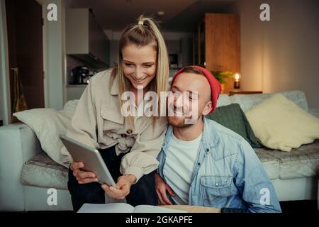 Caucasian happy couple working from home using digital tablet Stock Photo