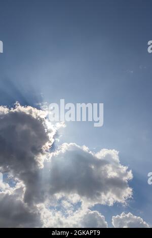 Sun peeking through the clouds background Stock Photo