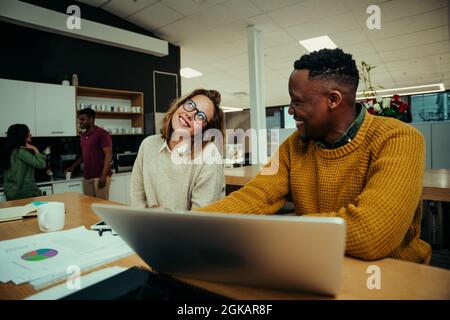 Caucasian female business woman giggling at male colleague making jokes while relaxing during lunch break  Stock Photo