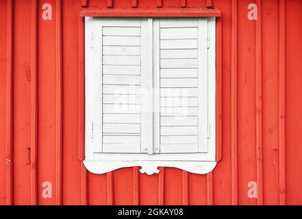 White wooden shutter on a red wall. Stock Photo