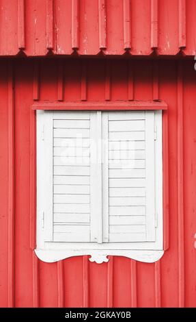 White wooden shutter on a red wall. Stock Photo