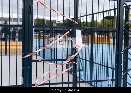 white barrier with red stripes on the background of stadium. Stock Photo
