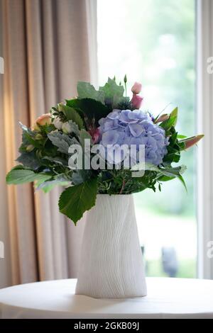 A beautiful multi-colored bouquet of hydrangeas on the table. Home comfort. High quality photo Stock Photo