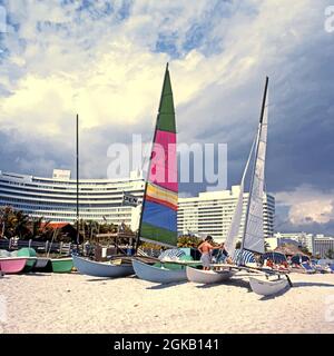 Catamarans on the beach with the Fontainebleau Hilton hotel to the rear, Miami, Florida, USA. Stock Photo