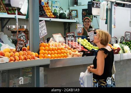 Customer being served at a fruit and veg stall in the indoor market (Mercado de Atarazanas), Malaga, Malaga Province, Andalucia, Spain, Western Europe Stock Photo