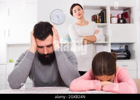 Mother lecturing husband and daughter Stock Photo