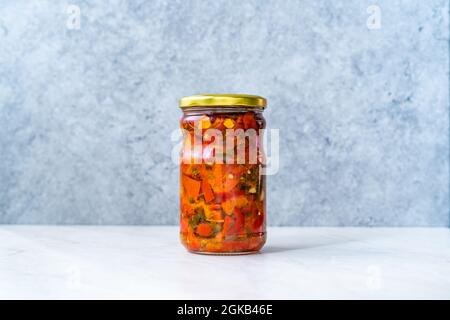 Preserved Vegetable Roasted Red Peppers with Garlic in Glass Jar. Ready to Eat. Stock Photo