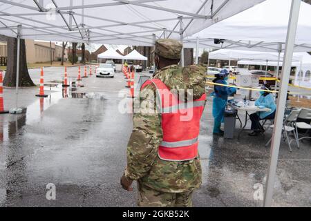 U.S. Army Spc. Daniel Quattlebaum, Company B, 198th Expeditionary Signal Battalion, South Carolina National Guard, directs patient vehicles through a COVID-19 mobile testing site in Hartsville, South Carolina, March 1, 2021. The South Carolina National Guard Soldiers have supported medical personnel at testing sites like this across the state since early 2020. The South Carolina National Guard remains ready to support the counties, state and local agencies, and first responders with resources for as long as needed in support of COVID-19 response efforts in the state. Stock Photo