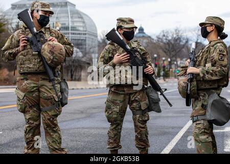 U.S. Army Pfc. Jocelyn Zavala, left, Pvt. Nicole Revilla and Spc. Samantha Pody, right, military police officers with the 933rd Military Police Company, Illinois National Guard, all secure an area near the U.S. Capitol in Washington, March 1, 2021. The National Guard has been requested to continue supporting federal law enforcement agencies with security, communications, medical evacuation, logistics, and safety support to district, state, and federal agencies through mid-March. Stock Photo