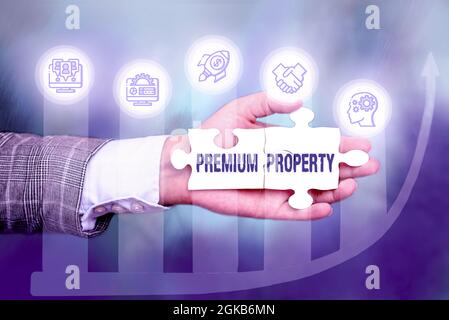 Conceptual caption Premium Property. Business overview upfront payment for a things belonging to someone Hand Holding Jigsaw Puzzle Piece Unlocking Stock Photo