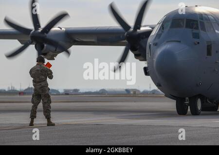Airman 1st Class Garrett Ferenz, 724th Air Mobility Squadron air transportation journeyman, marshals in a C-130J Super Hercules assigned to Ramstein Air Base, Germany at Aviano Air Base, Italy, March 3, 2021. It was the first time a 724th AMS Airman marshaled an aircraft at Aviano AB and trained with the 31st Maintenance Group. Trainings such as these provided Airmen an opportunity to become skilled multi-capable Airmen. Stock Photo