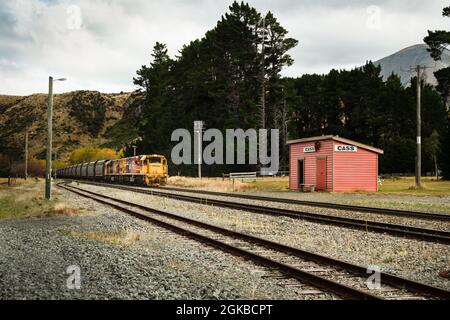 A KiwiRail freight train approaching Cass railway station, the highest section of the railway track linking Christchurch to Greymouth, South Island, N Stock Photo