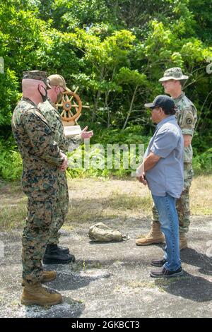 U.S. Marine Corps Col. Michael Nakonieczny, 31st Marine Expeditionary Unit (MEU) commanding officer, and U.S. Navy Capt. Brian Schrum, commanding officer of USS New Orleans (LPD 18), present a gift to Governor Temmy Shmall, Governor of Peleliu State, with U.S. Army Maj. Matthew See from Task Force Oceania on the Island of Peleliu, Republic of Palau, March 3, 2021. The 31st MEU is operating aboard ships of the Amphibious Squadron 11 in the 7th fleet area of operations to enhance interoperability with allies and partners and serve as a ready response force to defend peace and stability in the In Stock Photo