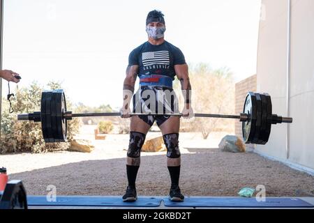 Staff Sgt. Vincent Cavazos, 56th Security Forces Squadron base defense operations control center controller, deadlifts 405 pounds in a strongman competition, March 3, 2021, at Luke Air Force Base, Arizona. The deadlift was one of eight events that participants had to complete during  the contest. Fitness events boost morale and contribute to a fit-to-fight Air Force. Stock Photo