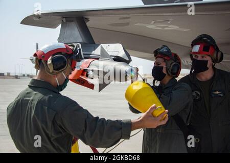 210303-M-UY835-1052 AL UDEID AIR BASE, Qatar (March 3, 2021) – U.S. Marines assigned to Marine Medium Tiltrotor Squadron 164 (Reinforced), 15th Marine Expeditionary Unit (MEU), prepare an AIM-9 Sidewinder missile mounted on a Marine Corps F-35B Lightning II during a U.S. Air Forces Central (AFCENT) Agile Combat Employment (ACE) event at Al Udeid Air Base, Qatar, March 3. AFCENT’s ACE capstone event enhances theater airpower competencies, validating operational capabilities and command and control while simultaneously strengthening regional partnerships. The 15th MEU is deployed to the U.S. 5th Stock Photo