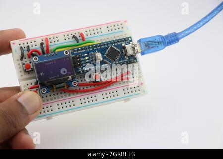 Arduino mini game prototype project made from OLED display and programmable controller on Breadboard Stock Photo