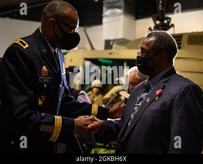 U.S. Army Brig. Gen. James M. Smith, U.S. Army Chief of Transportation, congratulates Ronald Mallory, a Vietnam War Veteran, after his receipt of the Bronze Star medal at the U.S. Army Transportation Museum on Joint Base Langley-Eustis, Virginia, Mar. 4, 2020. Mallory received the Bronze Star for his actions in the Vietnam War, in which his convoy was ambushed and he saved the lives of two of his team members. Stock Photo