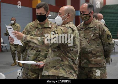 U.S. Air Force Lt. Gen. Michael A. Loh, director, Air National Guard and U.S. Army Maj. Gen. Jose Reyes, adjutant general, Puerto Rico National Guard, greet Soldiers assigned to a COVID-19 immunization site at the Pedrín Zorrilla coliseum Puerto Rico, March 5, 2021. Loh and Reyes visited the Pedrín Zorrilla coliseum to thank Guardsmen for serving throughout the pandemic. Stock Photo