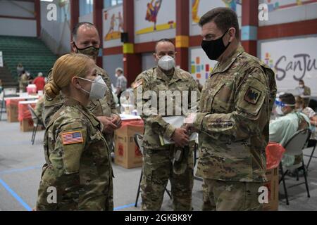 U.S. Air Force Lt. Gen. Michael A. Loh, director, Air National Guard and U.S. Army Maj. Gen. Jose Reyes, adjutant general, Puerto Rico National Guard, greet Soldiers assigned to a COVID-19 immunization site at the Pedrín Zorrilla coliseum Puerto Rico, March 5, 2021. Loh and Reyes visited the Pedrín Zorrilla coliseum to thank Guardsmen for serving throughout the pandemic. Stock Photo