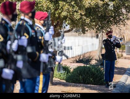Sgt. 1st Class Nicole Daley, a trumpet player assigned to the 82nd Airborne Division Band, plays taps during a funeral service for Pfc. Harvey Brown, a World War II veteran formerly assigned to 2nd Battalion, 505th Parachute Infantry Regiment, at Fort Bliss National Cemetery on Fort Bliss, Texas, March 5, 2021. Pfc. Brown was one of less than 3,000 Paratroopers to make all four combat jumps during World War II and fought in Italy, France, The Netherlands and Belgium. Stock Photo