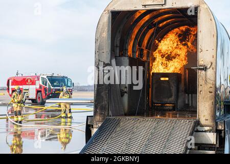 U.S. Air Force firefighters assigned to the 139th Fire Emergency Services, Missouri Air National Guard, and local civilian agencies conduct a live fire simulation during a major accident response exercise at Rosecrans Air National Guard Base, St. Joseph, Missouri, March 5, 2021.  The exercise allows first responders to practice various emergency scenarios including aircraft crash, missing child, and civil disturbance. Stock Photo